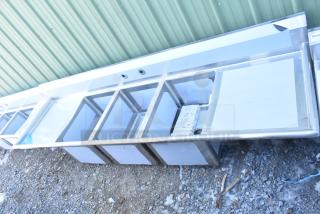 Three-compartment Regency 600S31824224 stainless steel sink with 2 drainboards, scratch and dent, no legs.