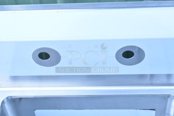 Regency 600S31824224 stainless steel sink, scratch and dent, three compartments, two drainboards, no legs.