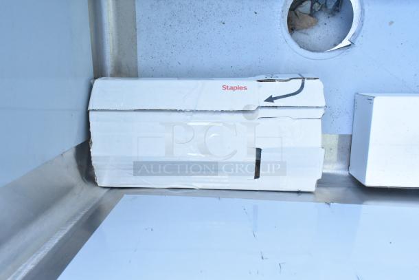 Brand new Regency 16-gauge stainless steel commercial sink with three compartments and two drainboards, no legs, visible packaging.