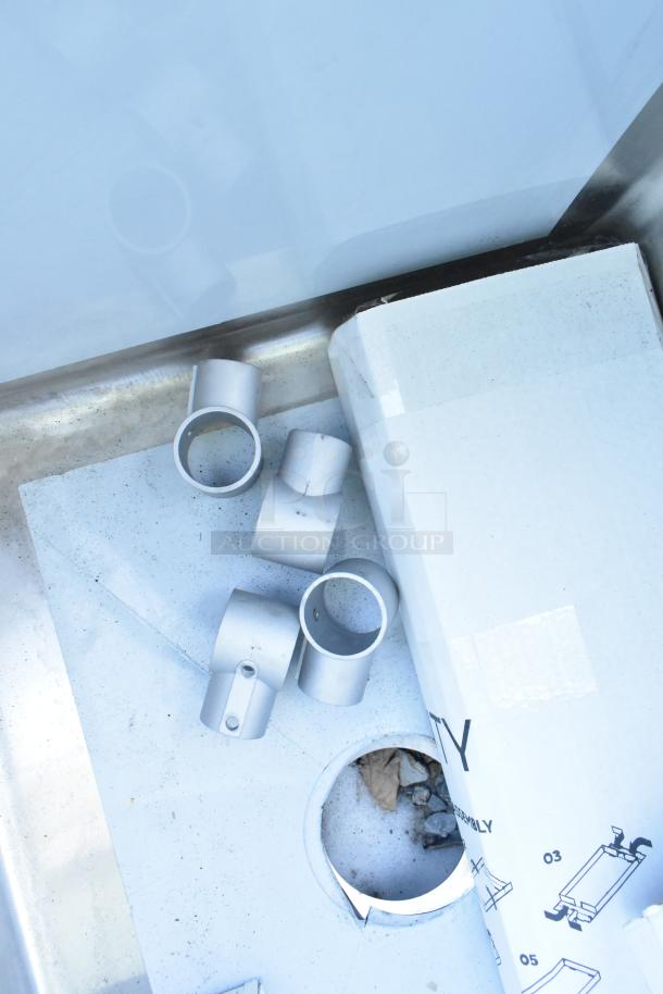 Stainless steel three-compartment sink, Regency 600S31824224, with two drainboards, no legs, scratch and dent, brand new.