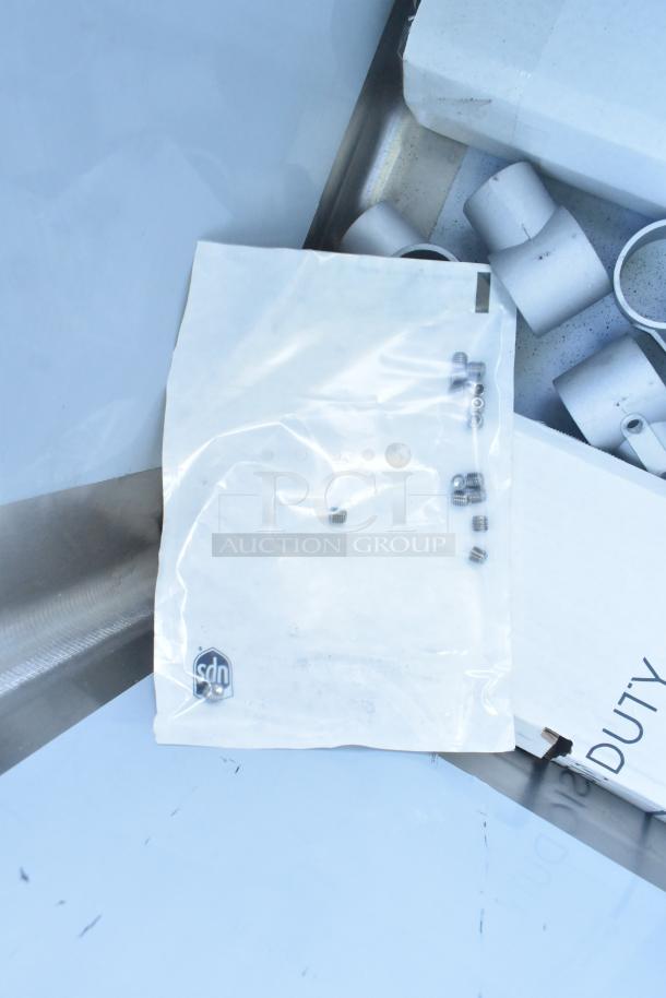 Brand new Regency 600S31824224, 16-gauge stainless steel, three-compartment sink with two drainboards, no legs, in scratch and dent condition.