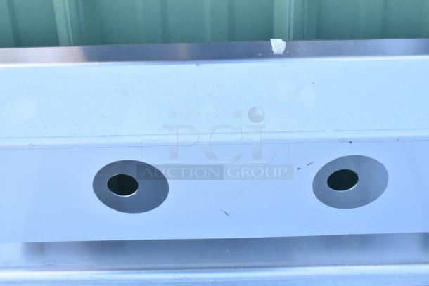 Brand new Regency 600S31818218 commercial sink with minor scratches; stainless steel, 94", 16 gauge, 3 compartments, 2 drainboards.