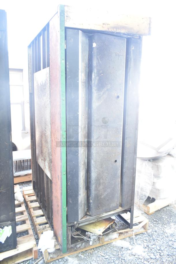 Montague 24P-2 gas pizza oven, single deck, industrial use, visible wear, rust, sits on a pallet, Montague branding.