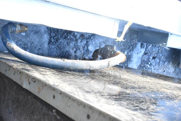 Montague 24P-2 commercial natural gas pizza oven, single deck, used. Visible gas connection hose and fittings.