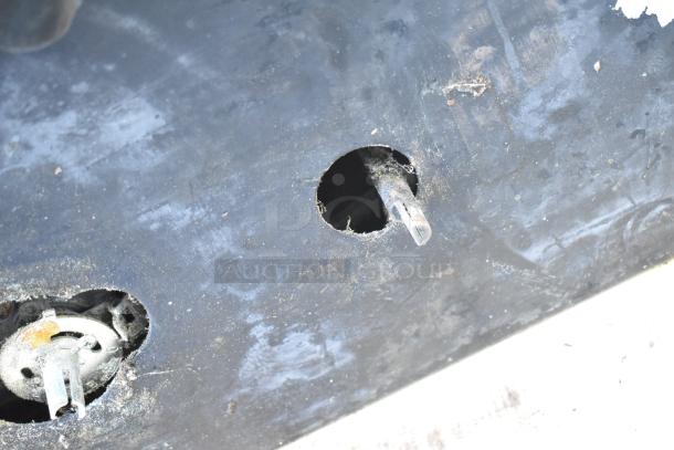 Montague 24P-2 pizza oven underside showing worn components in need of maintenance or repair.