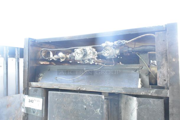 Montague commercial natural gas pizza oven, single deck. Visible wear, internal components, auction tag number 242.