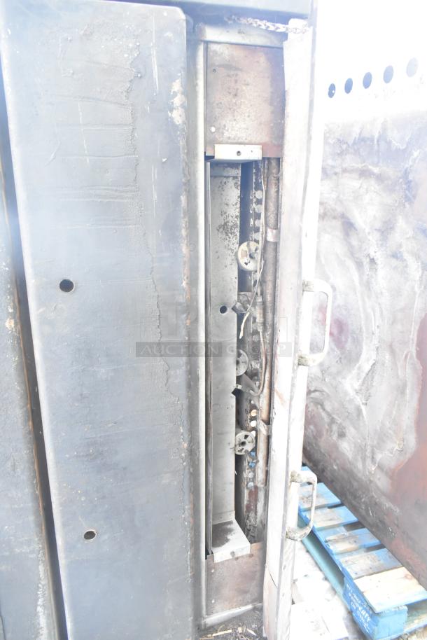 Montague Commercial Natural Gas Pizza Oven, single deck, used condition, visible wear, sturdy metal construction, side view.