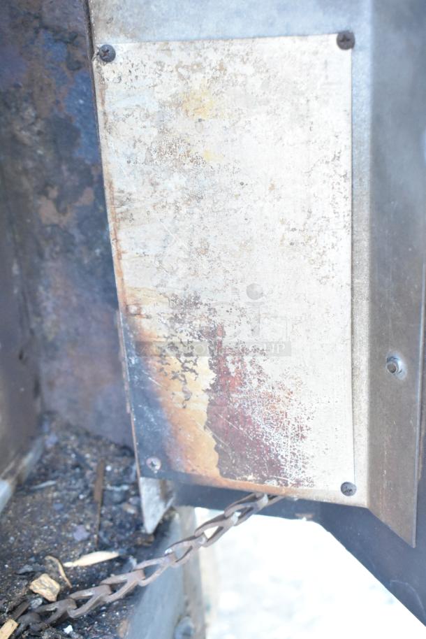 Montague Commercial Natural Gas Pizza Oven, single deck, metal surface with visible rust and wear, chain attached.