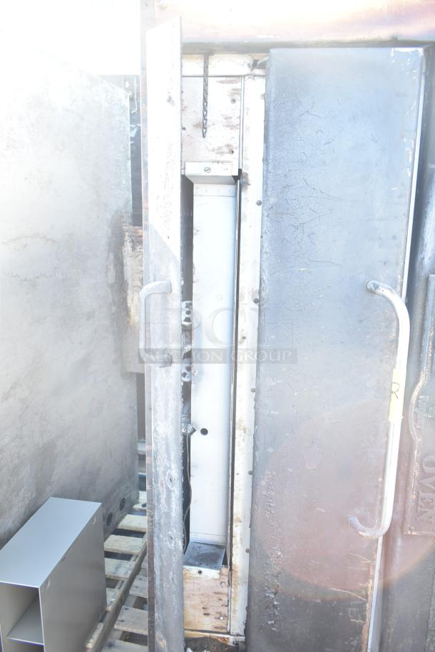 Montague 24P-2 commercial pizza oven, natural gas, single deck, visible wear, sturdy handles, large interior capacity.