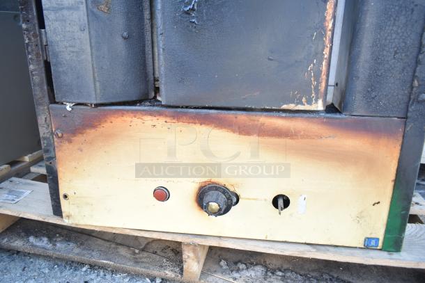 Montague 24P-2 commercial natural gas single deck pizza oven, showing wear and discoloration on control panel.