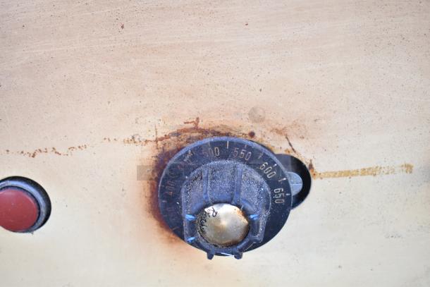 Montague 24P-2 pizza oven control panel with visible temperature settings, showing wear.