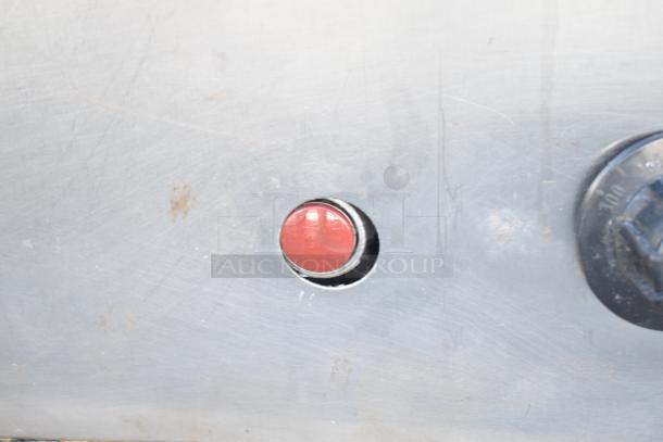 Montague commercial pizza oven control panel detail with a red button and a temperature dial.