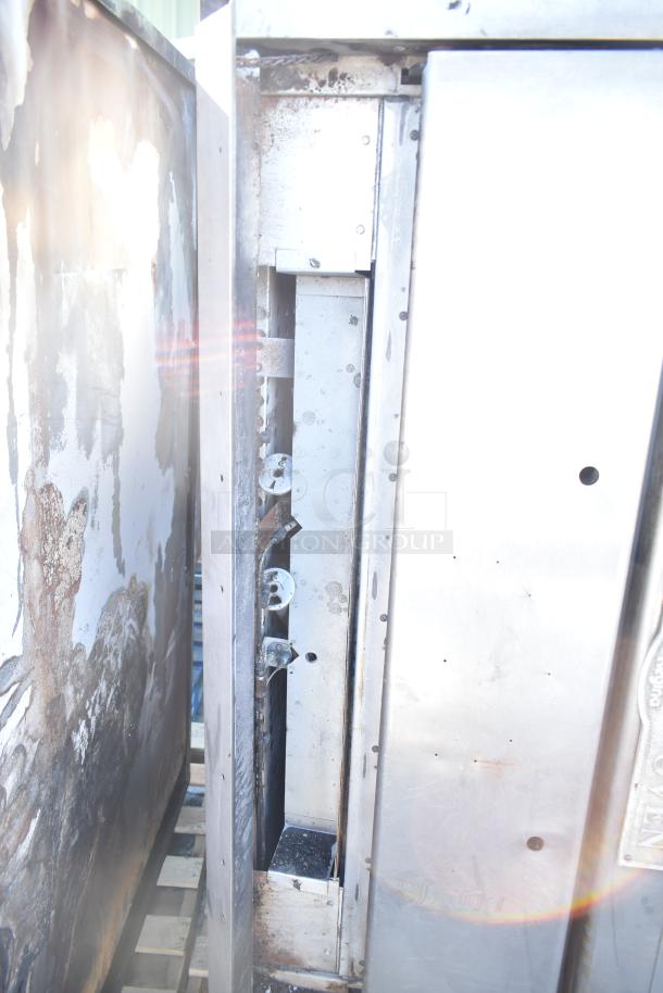 Montague commercial natural gas single deck pizza oven, visible burners, used condition, stainless steel exterior.