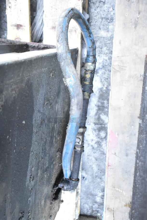 Close-up of the Montague commercial natural gas-powered single deck pizza oven hose, showing wear and use.