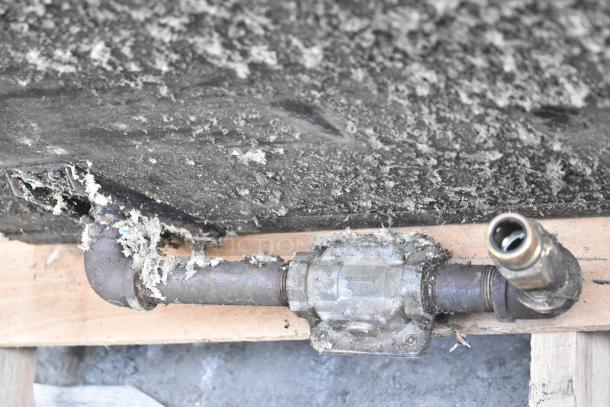 Montague Commercial Natural Gas Pizza Oven, single deck, with legs, showing underside piping and connections, used condition.