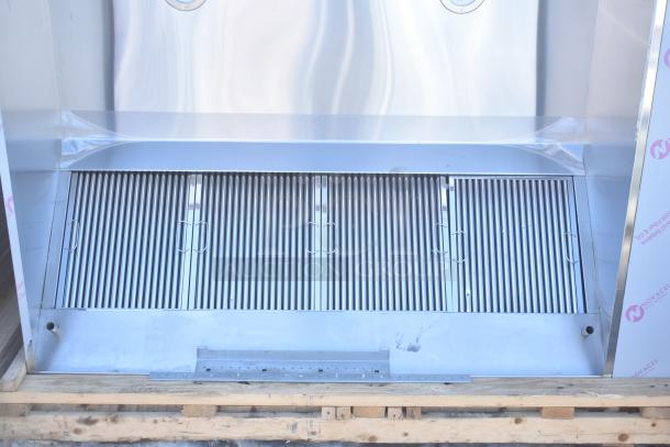 Brand new CaptiveAire 6024 ND-2WI commercial grease hood with filters and lights, minor scratches, wrapped on a pallet.