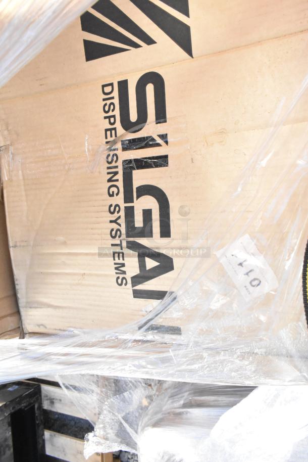 Packaging of Silgan Dispensing Systems, part of a new scratch and dent auction lot with multiple items including an ingredient bin.
