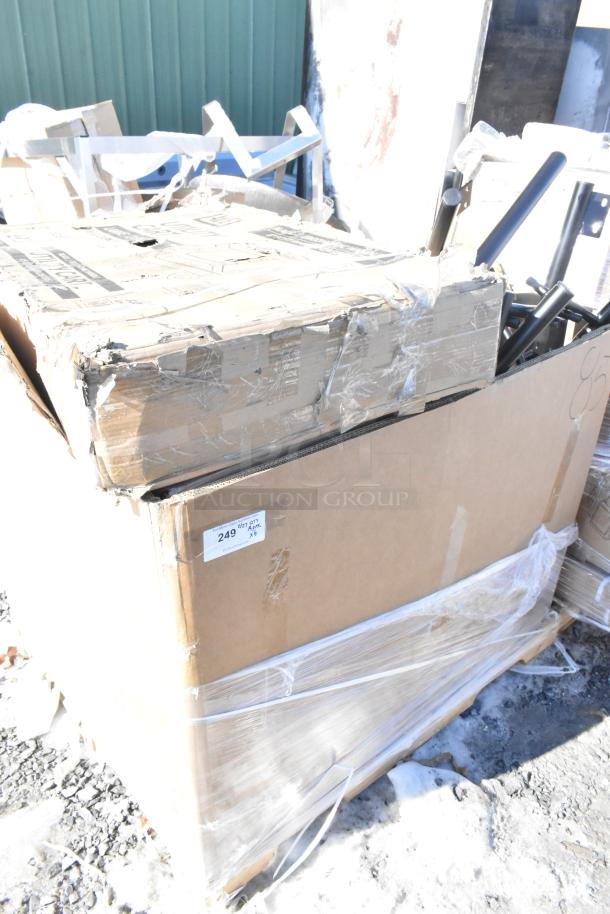 Cardboard box containing 6 new scratch and dent items, including a cart and toaster oven, wrapped in plastic. Label shows "249" and "x6".