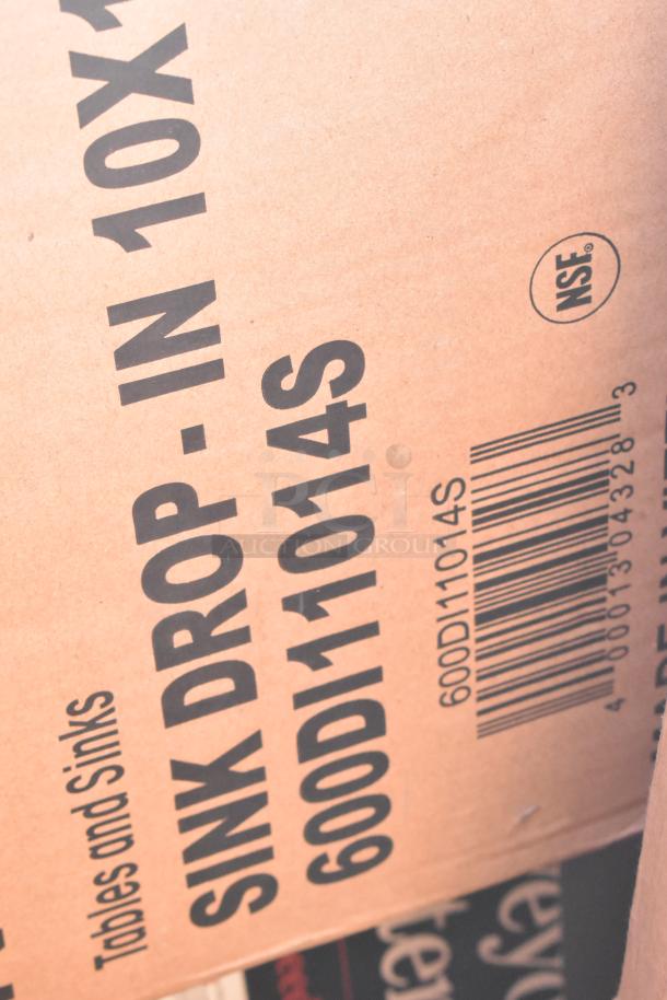 Cardboard box with "Sink Drop-In 600DI11014S" model number and NSF mark. Part of a brand new scratch and dent auction lot.