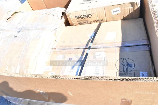 Box of six new scratch and dent items, includes Regency sink drop. Boxes with labels and packaging visible.