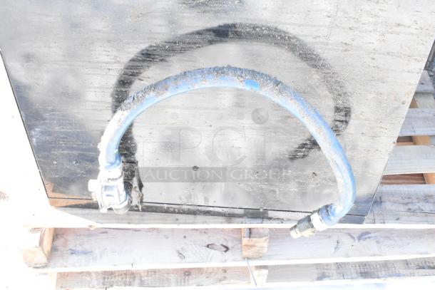 Montague commercial natural gas pizza oven, single deck, shown with attached blue gas hose, used condition.