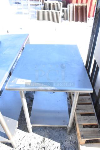 Stainless steel commercial table with under shelf, square top, moderate wear, labeled "251," suited for industrial use.