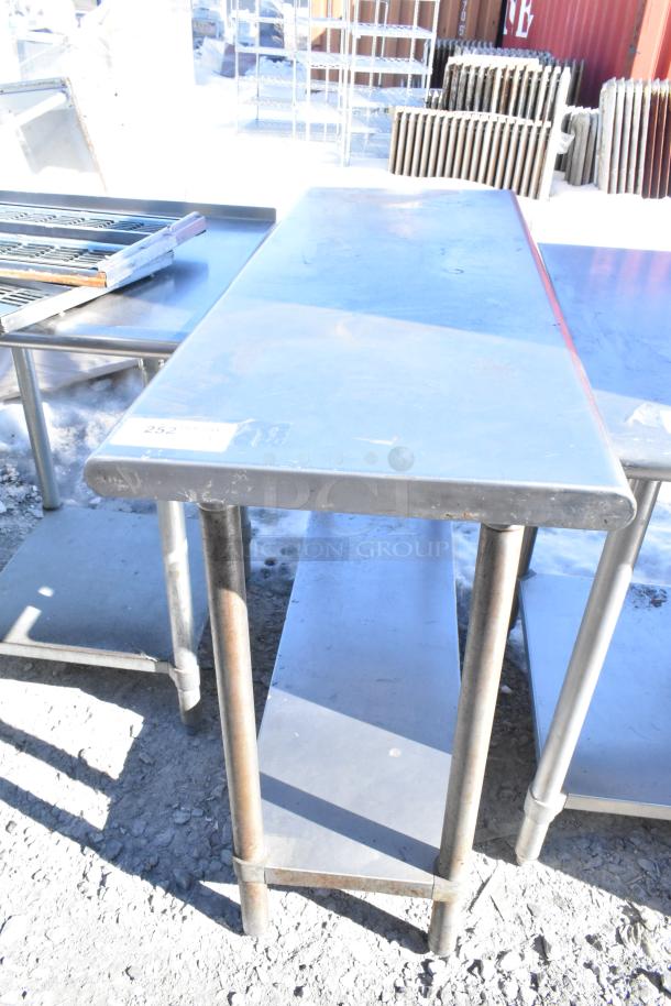 Commercial metal table with under shelf, rectangular shape, durable condition, visible label "252". Ideal for kitchen use.
