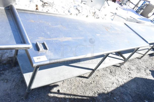Commercial stainless steel table with under shelf and vegetable slicer mount, shows wear, label reads "255".