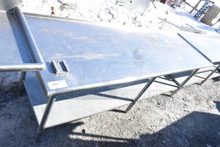 Commercial stainless steel table with under shelf and vegetable slicer mount, shows wear, label reads "255".