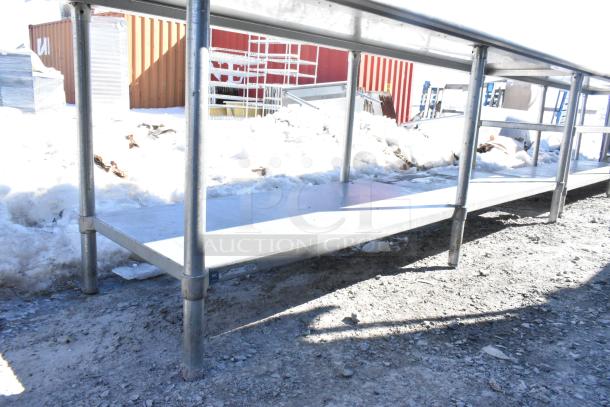 Commercial table with under shelf and vegetable slicer mount, stainless steel, sturdy construction, outdoor setting, excellent condition.