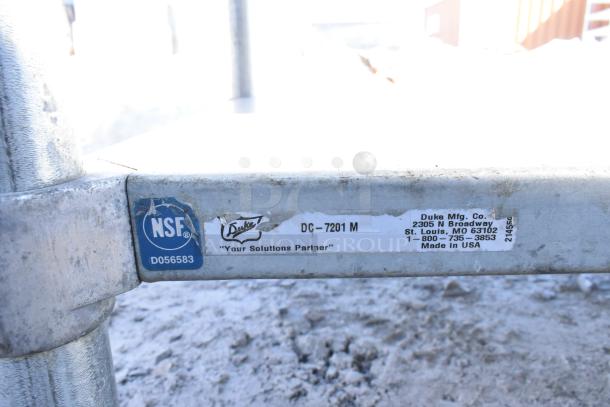 Commercial table by Duke Mfg. Co., model DC-7201 M, with under shelf and vegetable slicer mount, NSF certified.