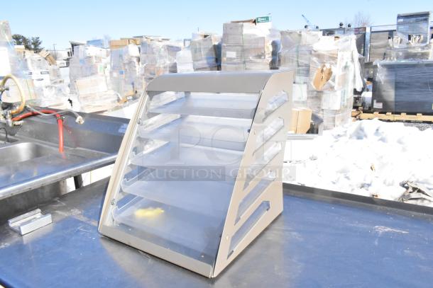 Nemco countertop dry cookie merchandising case with multiple shelves, clear sides, and aluminum frame, in used condition.