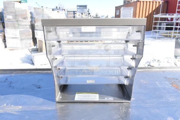 Nemco countertop dry cookie merchandising case, clear display with four shelves, visible label, in good condition.