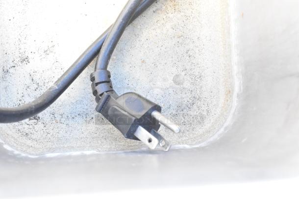 Nemco 6130-SUB food warmer plug in a stainless steel well, showing signs of light use. 120V, 1 Phase.