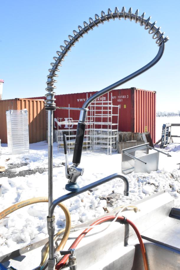 Commercial 3 bay sink with dual drain boards, faucet, handles, and spray nozzle. Clean and in good condition.