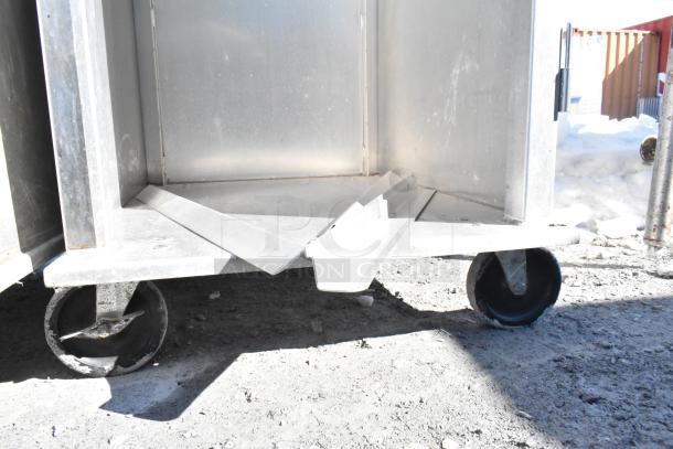 2 commercial pan transport racks on durable commercial casters, made of sturdy metal, in used condition.