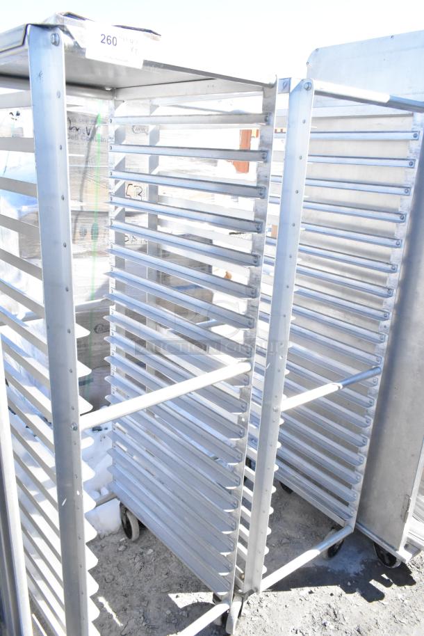 Two commercial pan transport racks with multiple shelves, aluminum construction, on casters, used condition, auction lot 260.