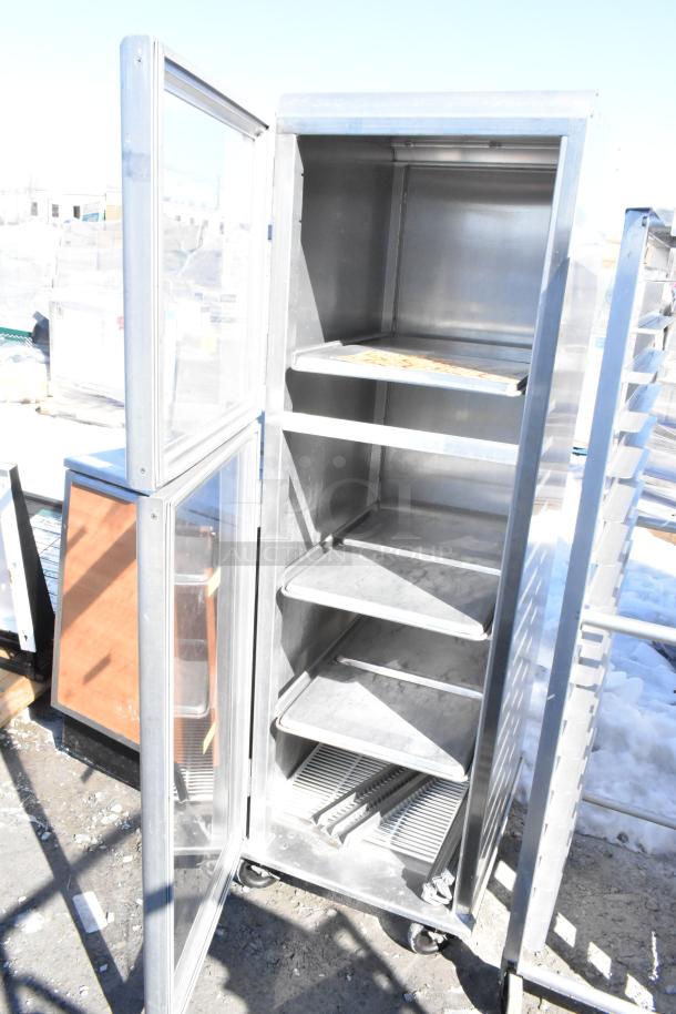 Lockwood enclosed pan transport rack with shelves, commercial casters, metal construction, open door, used condition.