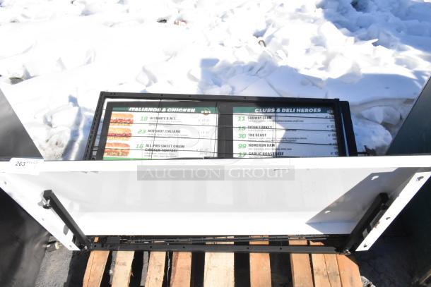 Outdoor menu signboard featuring sandwich selections and prices, labeled "Italianos & Chicken," in used condition on a pallet.