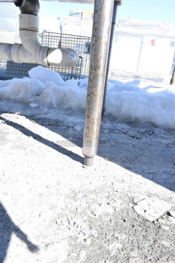 Commercial 2 bay sink with dual drain boards, featuring stainless steel design, visible pipe connections, and sturdy legs.