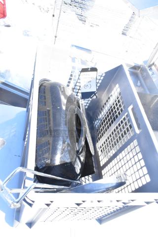 Lot of miscellaneous items in a gray bin; includes black plastic item and metal frame. Tag reads "Italian Sausage 020 (45)."