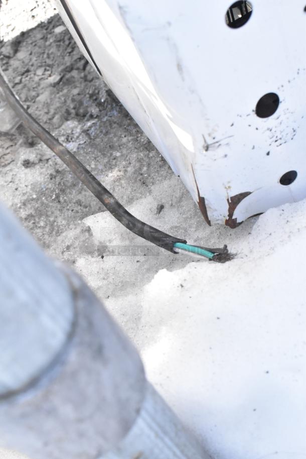 Coldline BD-600 Chest Freezer; 115 volts, 1 phase. Visible rust and wear on exterior, exposed wiring indicates repair needed.