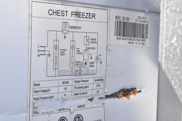 Coldline BD-600 Chest Freezer, 115 volts, labeling shows model and electrical diagram, rust visible on surface.