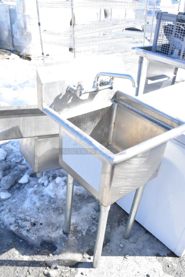 Commercial single bay sink with faucet and handles, stainless steel, sturdy construction, outdoor setup, clean condition.