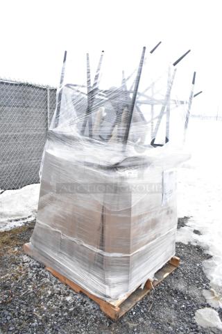 Pallet of 12 new scratch and dent items, including chairs, wrapped in plastic, visible labels with lot number 219.