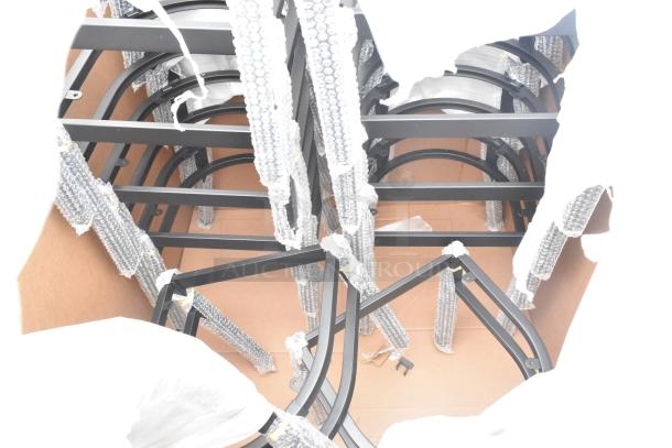 12 new scratch and dent items in a package, including dishtable and chair frames, partially bubble-wrapped.