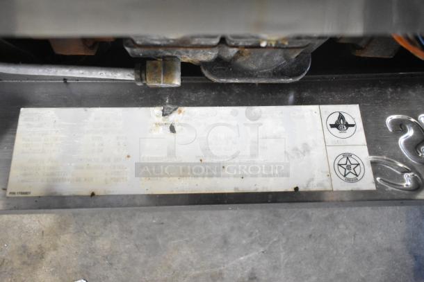 Label on Garland SunFire Natural Gas Convection Oven, showing certification marks; metal surface with some wear visible.