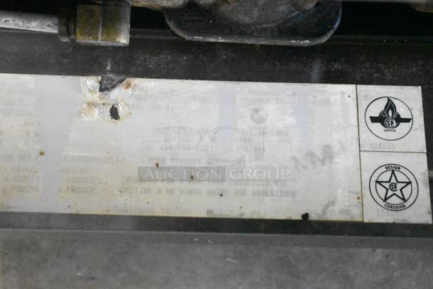 Label on Garland SunFire Convection Oven shows certification marks and usage guidelines. Markings are partially worn.