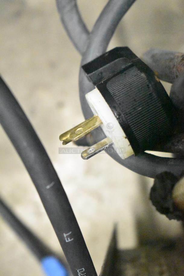 Plug of Taylor RD30-12 frozen drink machine, 115 volts, 1 phase. Close-up view, showing plug prongs and cable markings.