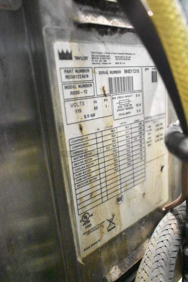 Taylor RD30-12 frozen drink machine label, showing model, volts (115), phase, and serial number. Used condition.